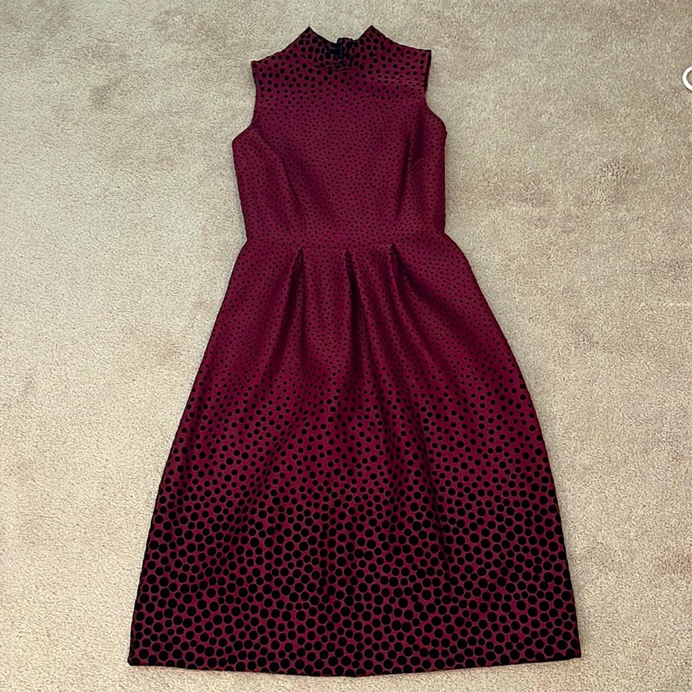 Adorable mod style peplum dress in a purple/magenta color.